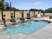 Image of a Fiberglass Pool with a Granite Finish in a Residential Backyard