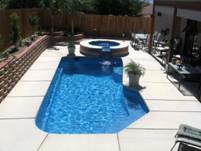 Image of an In-ground Pool with a Spill-over Spa Customized with the Sapphire Blue Pools Finish