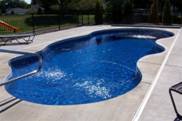 Image of a Free-Form In-ground Fiberglass Pool with Built-in Streams in a Backyard in Oakville