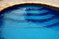 Image of Steps in an In-ground Fiberglass Pool Customized with Ceramic Inlayed Tiles