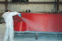 Image of an Interpools Employee adding the Standard Gel-Coat, the Premium Crystite or the Diamond Series Finish to a Fiberglass Pool