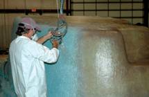Image of an Employee Strategically Placing Additional Layers of Vinyl Ester Resin and Hand Laid Fiberglass for Durability and Strength
